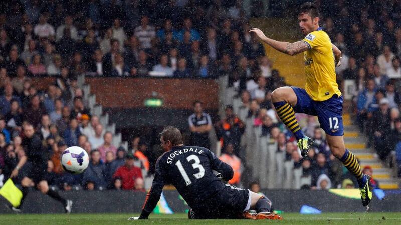 Arsenal’s Olivier Giroud scores past Fulham’s goalkeeper David Stockdale at Craven Cottage. Photograph: Stefan Wermuth/Reuters