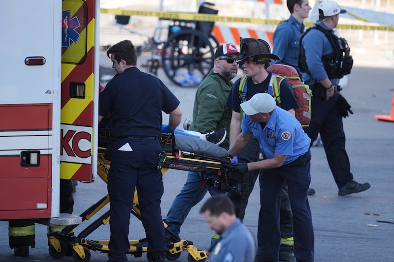 One of the victims is loaded into an ambulance. Photograph: Charlie Riedel/AP