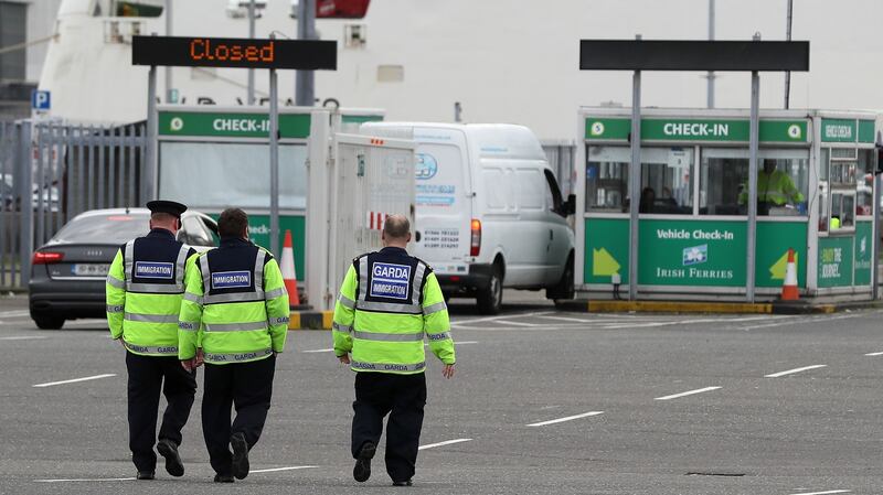 Garda immigration officers are seen at Dublin Port. A man in his twenties and wanted for questioning by police in Essex was arrested at the port on unrelated charges. Photograph: PA