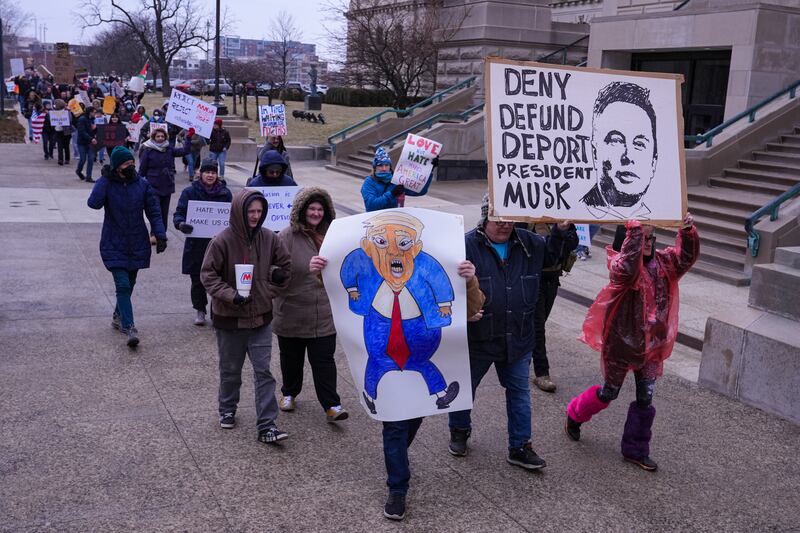 Protesters march around the Statehouse in Indianapolis, US (Michael Conroy/AP)