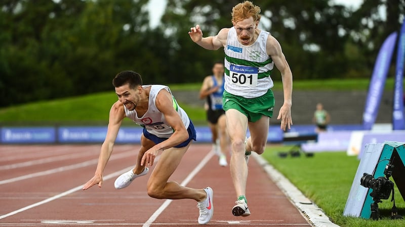 Paul Robinson (left) dives across the  finish line to win the men’s 1,500m, ahead of Sean Tobin. Photograph: Sam Barnes/Sportsfile