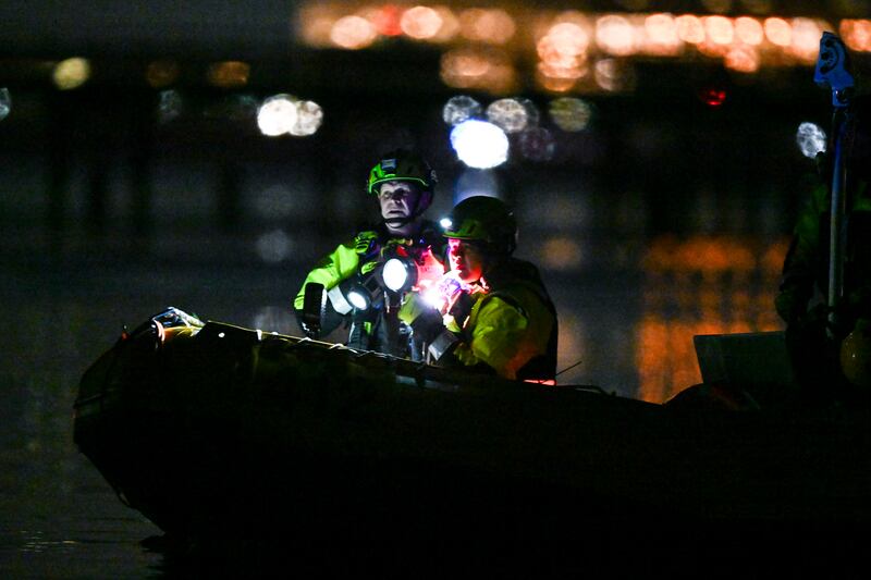 Emergency workers investigate the wreckage in the Potomac River  on Thursday. Photograph: Kenny Holston/The New York Times
                      