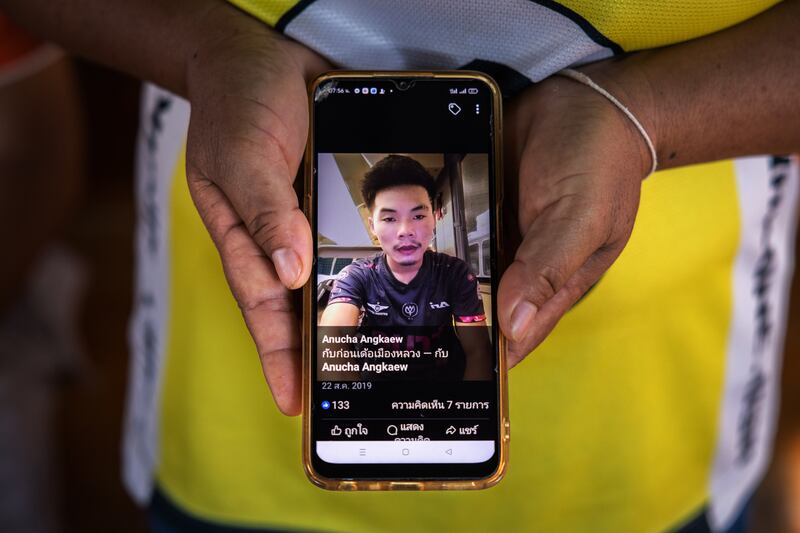 Watsana Yojampa shows a photograph of her son Anucha Angkaew, who was working in Israel as a farm hand when he and dozens of Thais were killed or taken hostage in the October 7th attack by Hamas, at her home in Thailand’s Udon Thani province. Photograph: Lauren Decicca/New York Times
                      