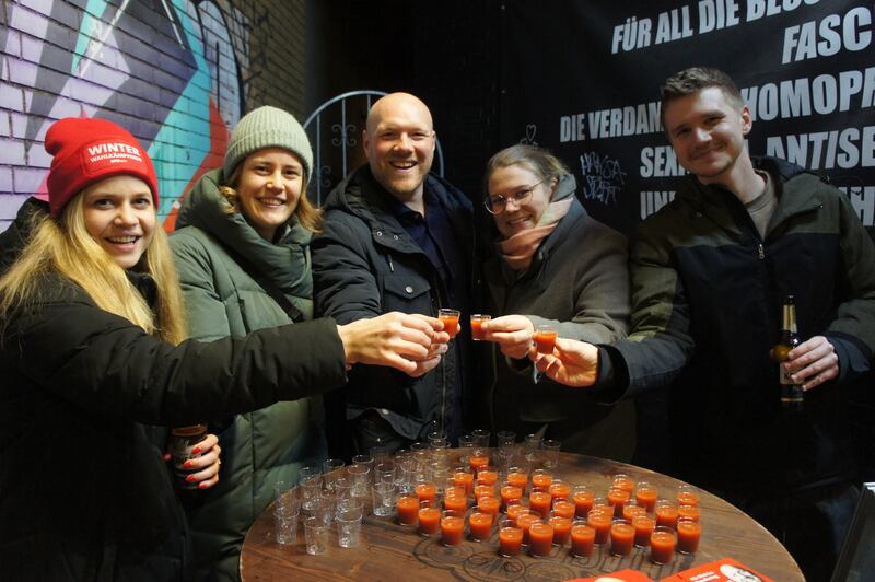 Dortmund MP Jens Peick (centre) distributes shots to revellers ahead of Sunday's federal election in Germany. Photograph: Derek Scally