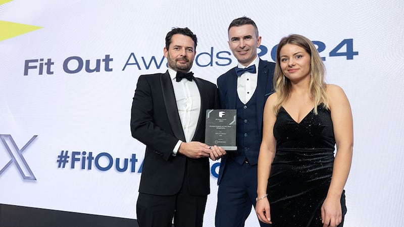 Iain Wogan, CEO and head of sales of Whiteriver Group, presents the fit out project of the year - hospitality award to Martin Spillane and Elizabete Jakobsone, MDO Architects