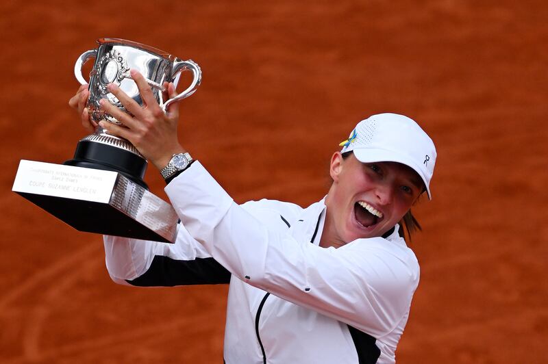 Iga Swiatek celebrates with her winners trophy after victory against Karolina Muchova in the 2023 French Open final. Photograph: Clive Mason/Getty Images