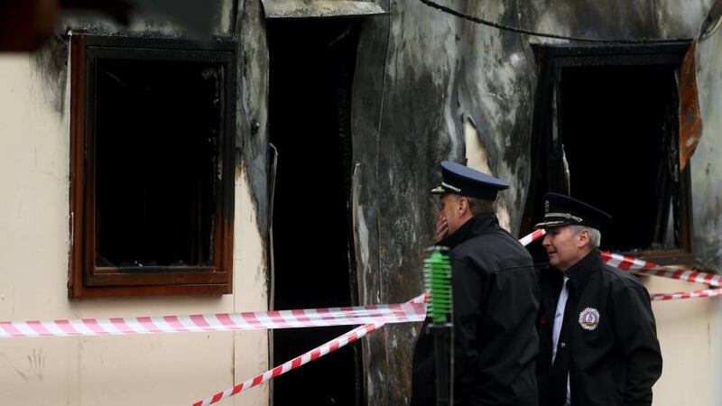 Shocking: Chief Fire Officer Pat Fleming and Assistant Chief Fire Officer Dennis Keeley at the scene of the fire that killed 10 people, including five children, at a halting site for Travellers in Carrickmines. Photograph: Brian Lawless/PA Wire