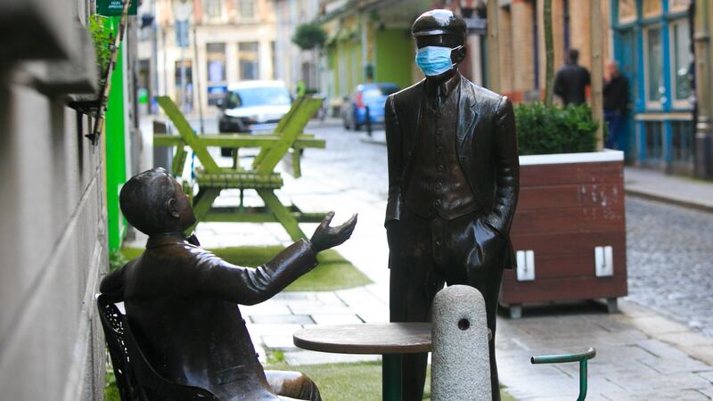 A statue wearing a face mask outside the Oliver St John Gogarty pub in Temple Bar during the Covid-19 lockdown, in Dublin’s city centre. Photograph: Gareth Chaney/Collins