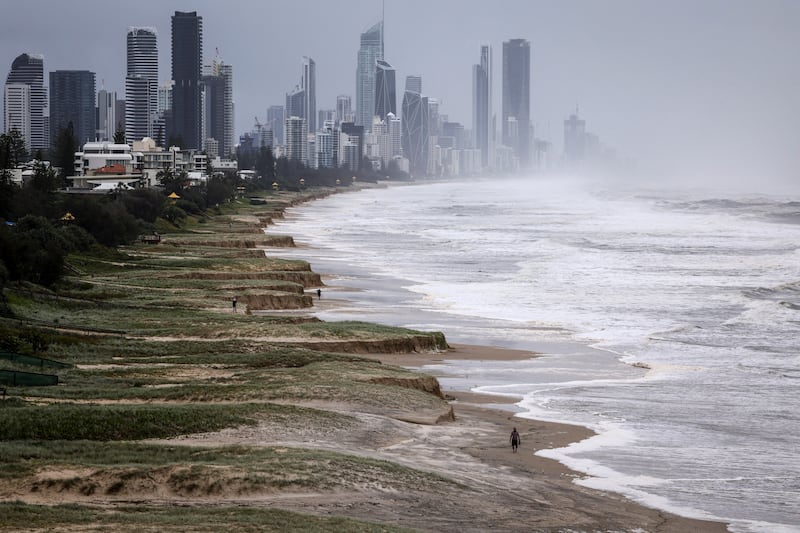 Residents walk along the damaged foreshore of Nobby's Beach located on the southern end of the Gold Coast. Photograph: David Gray/AFP