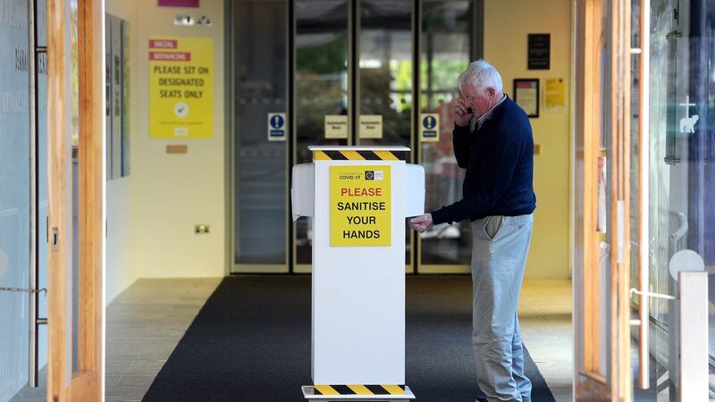 Visitor using hand sanitiser on his way into the basilica. Photograph: Conor McKeown