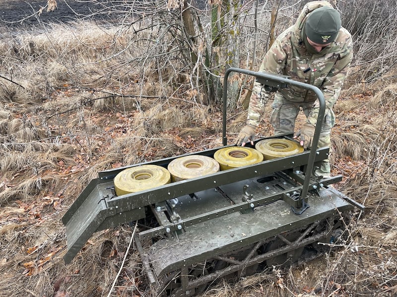 Vitaliy, a drone operator and technician with Ukraine's 113th territorial defence brigade, with the Ukrainian-made Volya-E land drone that can be used on the front line to evacuate injured soldiers, deliver supplies or lay land mines. Photograph: Daniel McLaughlin