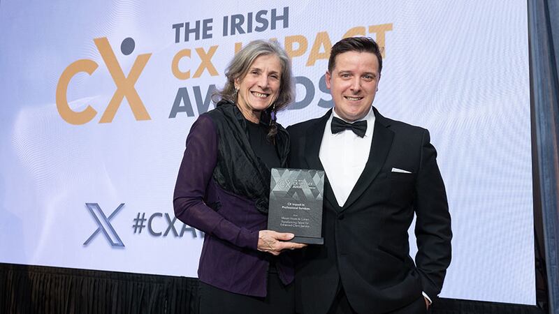 Jan Richards, awards judge, presents the CX impact in professional services award to Cian O'Daly, Mason Hayes & Curran