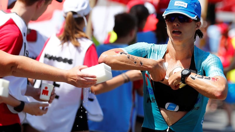 Leading athlete Sarah True of the US tries to cool down while competing in the Ironman triathlon European Championships in Frankfurt, Germany, on Sunday. She collapsed moments later.  Photograph: Kai Pfaffenbach/Reuters