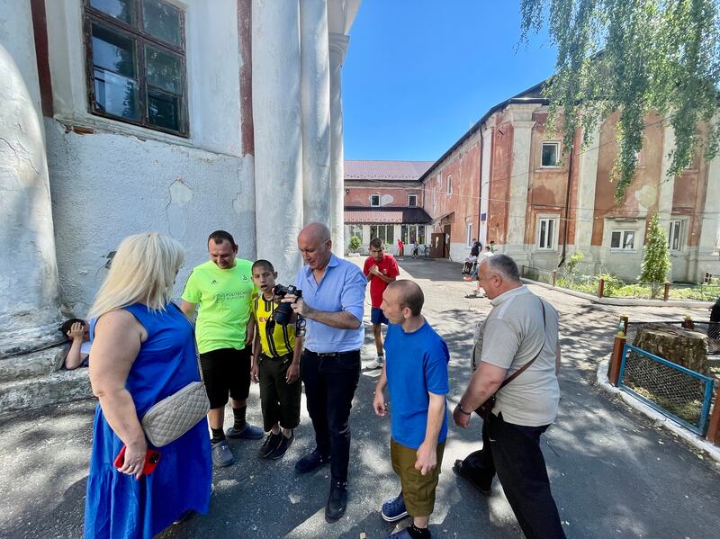 Tom McEnaney, founder of Irish charity Effective Aid Ukraine, centre, at the Rozdil special needs centre that the group is helping to renovate. Photograph: Daniel McLaughlin