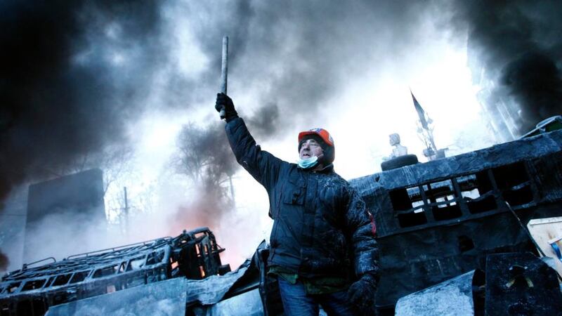 A man reacts at a barricade near the site of clashes between anti-government protesters and riot police in Kiev. Photograph: David Mdzinarishvili/Reuters