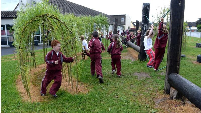 Darragh Crowley runs through the willow tunnel made by the children during the school’s active schools programme. Photograph: Brenda Fitzsimons