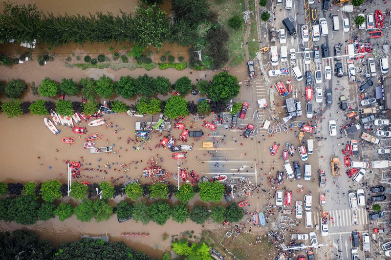 Rescue workers deploy life rafts for evacuating residents during floods in Zhuozhou in northern China’s Hebei province. Photograph: David Zhang via AP