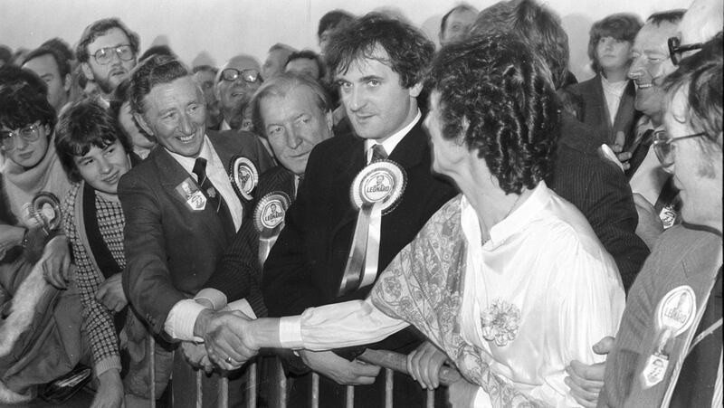 Tom Leonard, the successful Fianna Fail candidate in the Dublin Central by-election in November 1983, is congratulated by the Fine Gael candidate, Mary Banotti.  Between them stand Charlie Haughey and a young-looking Bertie Ahern, then Fianna Fail's director of elections.  Photograph: Paddy Whelan