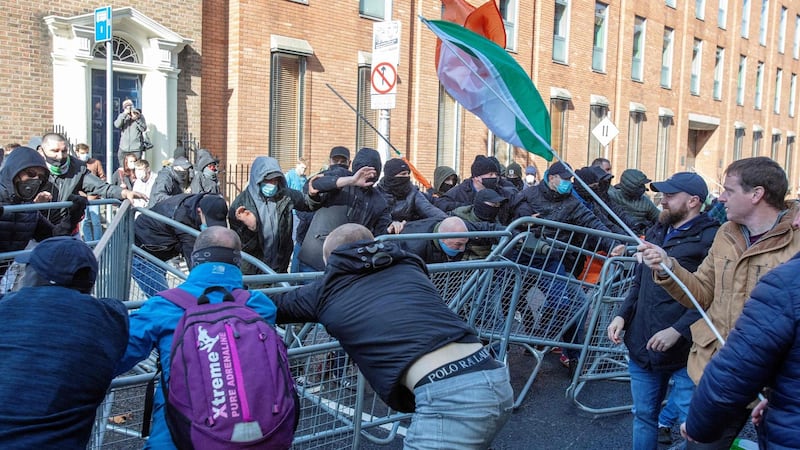 Counter-demonstrators (left) clash with activists protesting against the Government’s imposed restrictions put in place to help stem the rise in the number of  Covid-19 cases outside Leinster House on Saturday. Photograph: Paul Faith/AFP via Getty