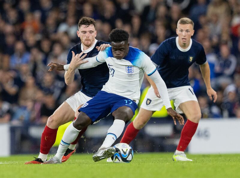 Andy Robertson of Scotland and Bukayo Saka of England during the friendly soccer match between Scotland and England at Hampden Park in Glasgow. Photograph: EPA