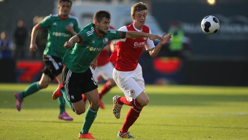 Legia Warsaw’s Lukasz Broz  and St. Patrick’s  Christopher Forrester compete for possession during the  Champions League Second Qualifying Round match at Tallaght Stadium last night. Photograph: Niall Carson/PA Wire.