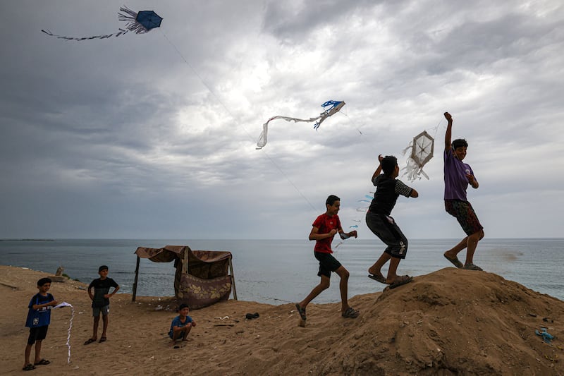 Children fly kites along a beach at al-Shati refugee camp in June. Photograph: Mahmud Hams/AFP via Getty Images