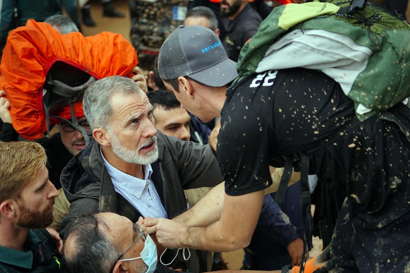 King Felipe VI of Spain talks with a person as a delegation was heckled as it visited the Valencia region hit by deadly floods. Photograph: Getty Images