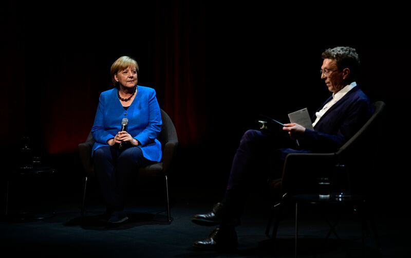 Former German Chancellor Angela Merkel (L) and German journalist Alexander Osang react on stage prior to the start of Merkel's first public talk since stepping down, at the Berliner Ensemble theatre in Berlin on June 7, 2022. (Photo by John MACDOUGALL / AFP) (Photo by JOHN MACDOUGALL/AFP via Getty Images)