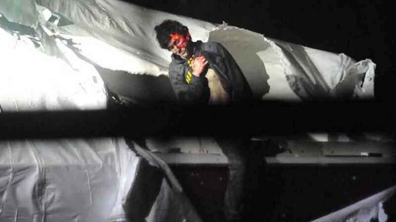 Boston bomb suspect Dzhokhar Tsarnaev in one of the dramatic pictures released without permission by Sgt Sean Murphy, a tactical photographer with the Massachusetts state police. He has been suspended from duty as a result.