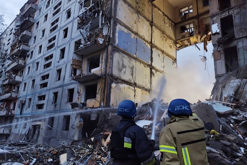 Rescuers use a hose to extinguish a fire in a residential building damaged after a strike in Zaporizhzhia, on October 9th. Photograph:  Maryna Moiseyenko/AFP via Getty