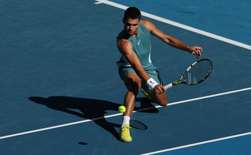 Carlos Alcaraz plays a backhand volley against Jack Draper. Photograph: Clive Brunskill/Getty