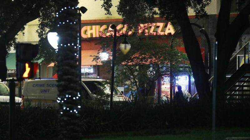 A crime scene unit van is seen as police investigate a shooting at the GLHF Game Bar, which uses the same entrance as the Chicago Pizza place at the Jacksonville Landing in  Florida. Photograph: Joe Raedle/Getty Images.