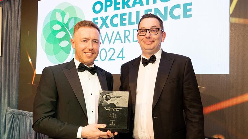 Mark M Cullen, senior project manager at Sensori FM, presents the operations manager / COO of the year to Adrian Curtin, ISS Ireland