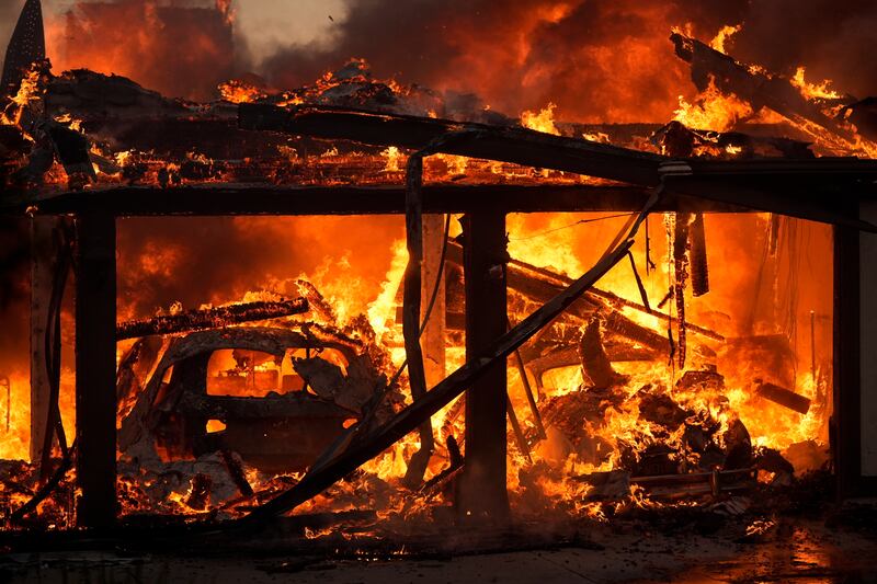 A home burns in the Mountain Fire in Camarillo, California. Photograph: Marcio Jose Sanchez/AP