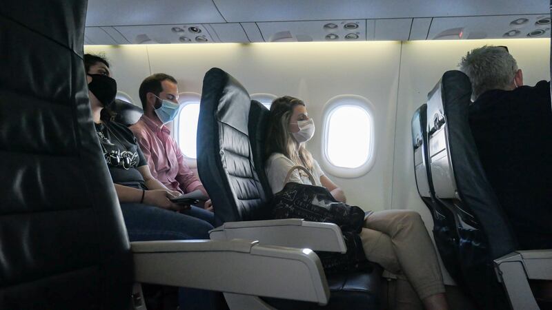 Passengers wearing face masks on an Olympic Air De Havilland Canada aircraft flying from Athens.  Certain  factors on board, such as raised seat backs, can help lessen virus transmission. Photograph:  Nicolas Economou/ NurPhoto via Getty Images