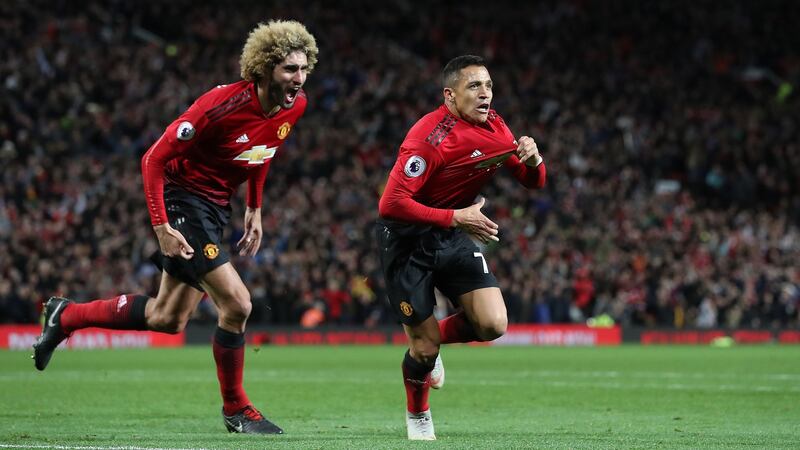 Manchester United’s Alexis Sanchez  celebrates scoring his side’s third goal of the game with Marouane Fellaini during the Premier League match against Newcastle United at Old Trafford. Photograph:  Martin Rickett/PA Wire