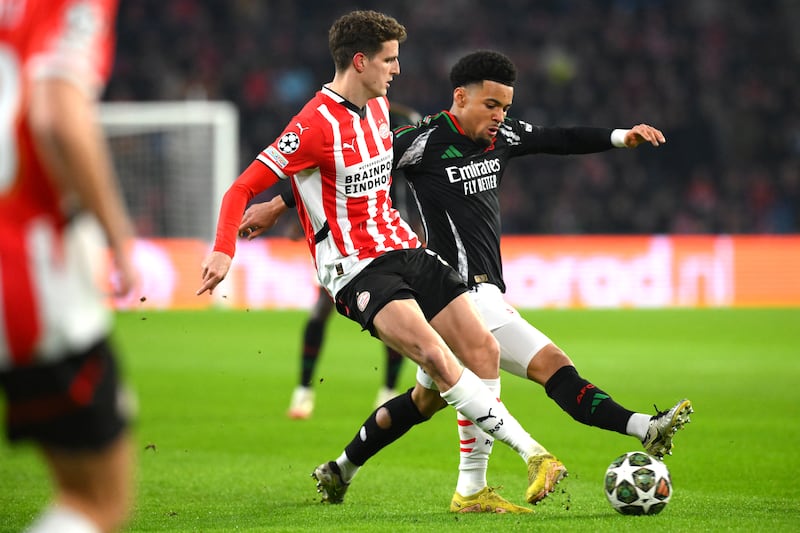 PSV Eindhoven's Guus Til is challenged by  Arsenal's Ethan Nwaneril during the  Champions League Round of 16, first leg at the Philips Stadion. Photograph: John Thys/AFP via Getty Images          