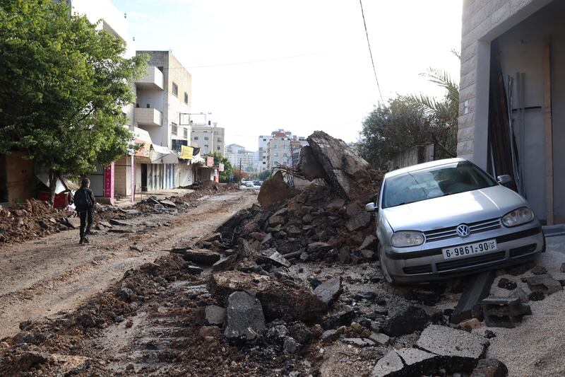 A Palestinian walks along a damaged street at the Jenin refugee camp following an Israeli raid in the occupied West Bank city of Jenin. Photograph: Alaa Badarneh/EPA