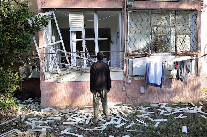 A resident examines a damaged house near the scene of a missile attack in Tel Aviv. Photograph: Abir Sultan/EPA-EFE