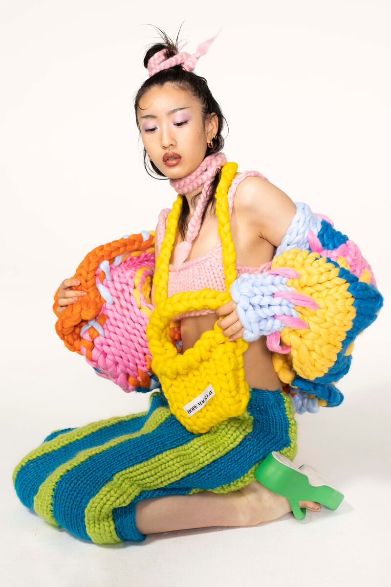 Colourful colossal knit jacket (£280), crossbody bag (£120), pink bralet (£100), mixed knit striped skirt (£230), pink bow hair tie (£30)