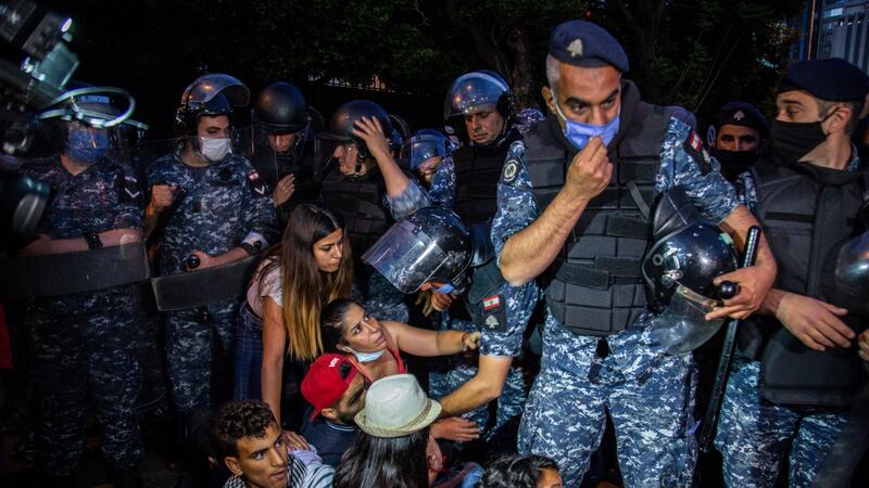 Riot policemen try to remove anti-government protesters  blocking a road in front of the Lebanese interior ministry during a protest against an economic and financial crisis, in the al-Hamra area of Beirut, Lebanon, in recent weeks. Photograph: Nabil Mounzer/EPA