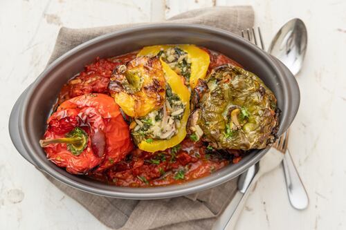 Spinach and mushroom stuffed bell peppers in a tomato and tarragon sauce