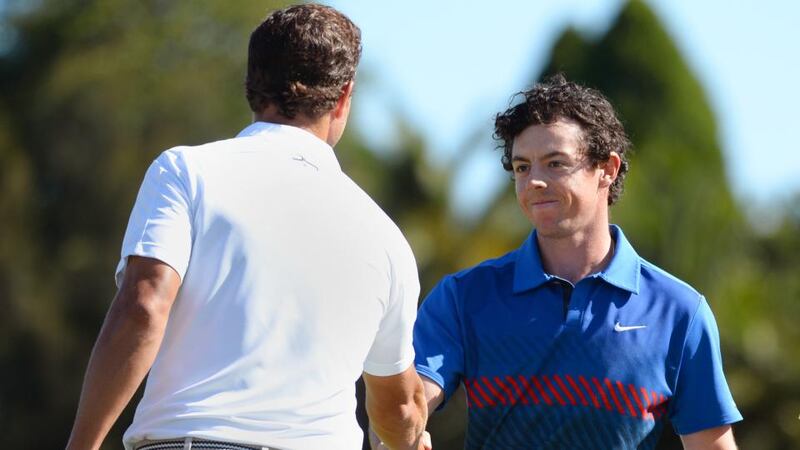 Rory McIlroy  is congratulated by home-hope Adam Scott  after clinching victory. Photograph: Getty Images