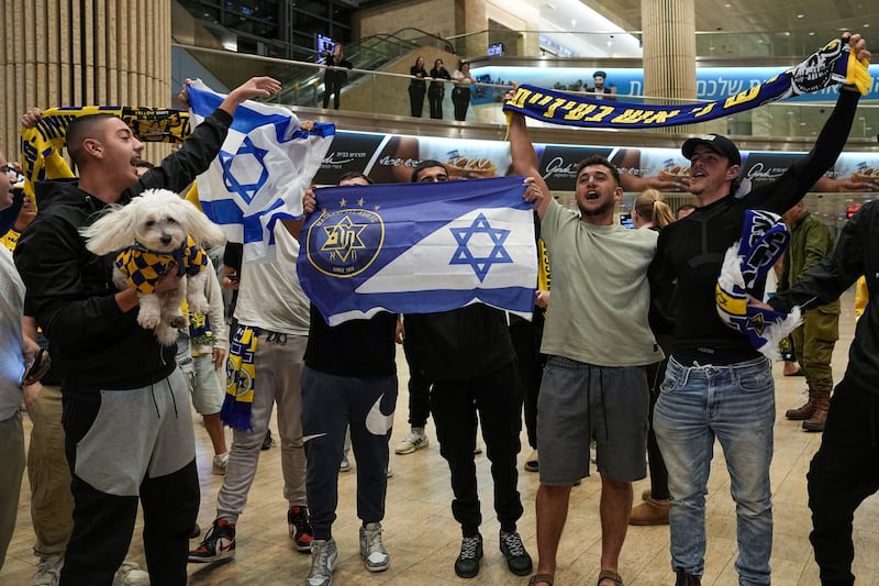 Maccabi Tel Aviv fans celebrate after arriving at Israel’s Ben-Gurion International Airport after the Dutch game. Photograph: Tsafrir Abayov/AP