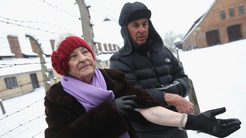 Rose Schindler (85) who is a survivor of the Auschwitz-Birkenau concentration camp, and her husand Max, who survived the nearby Plaszow camp, show their concentration camp tatoos while visiting the former Auschwitz  concentration camp. Photograph: by Sean Gallup/Getty Images