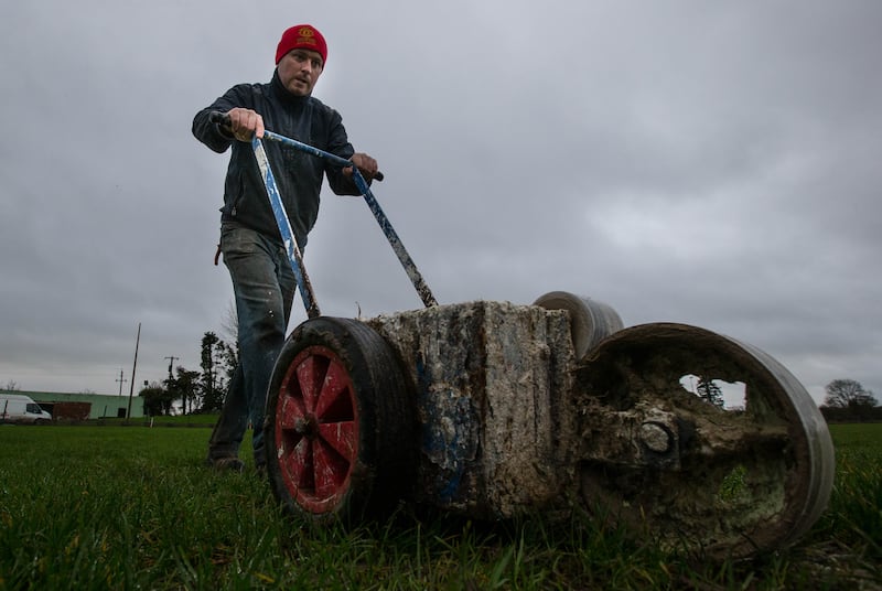 Caretaker John Paul Peters marks the pitch before a game Leahy Park in Cashel. Photograph: Cathal Noonan/Inpho