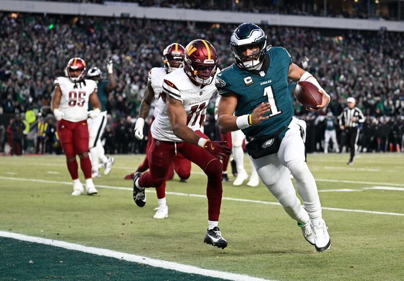 Philadelphia Eagles quarterback Jalen Hurt runs into the end zone for a touchdown during the NFC Championship game against the Washington Commanders. Photograph: John McDonnell/ for The Washington Post via Getty Images