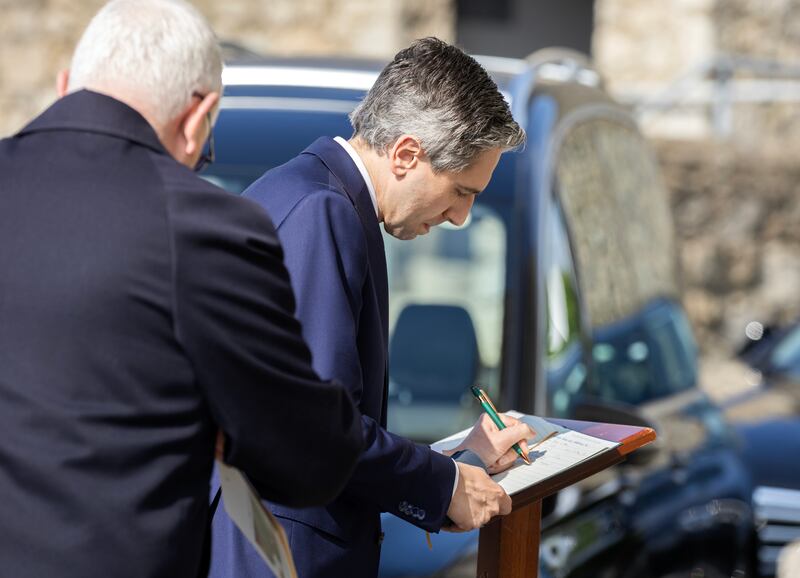 Taoiseach Simon Harris signs the book of condolence at the funeral on Thursday morning. Photograph: Colin Keegan/Collins Dublin