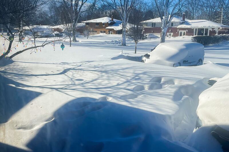 A car sits blanketed in snow on a driveway in Amherst, New York. Photograph: Delia Thompson/AP