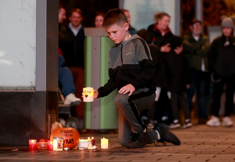 Jay Martin (8) places a candle among other tributes at a vigil for Kyran Durnin in Market Square, Dundalk, on Monday evening. Photograph: Liam McBurney/PA Wire 